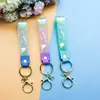 Llavero de accesorios de muñeca linda de cuerda de cuero de caucho suave pvc de arcoíris de deseo creativo accesorios de llavero para bolsa de pareja