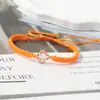 Pulsera tejida de nudo plano de trébol de cuatro hojas de venta caliente transfronteriza para parejas y estudiantes, tendencia europea y americana inspirada en la dopamina, joyería al por mayor de fabricante