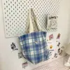 Otoño 2026 nuevo bolso de hombro a cuadros diseño coreano para mujer retro versátil para ir al trabajo bolsa de mano de gran capacidad