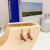 Aretes de gancho para la oreja de personaje de dibujos animados lindo goteando aceite de murciélago versión coreana 2022 personalidad combinable