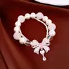 Pulseira com pingente de laço de zircônia com pérolas de dupla camada, toque de luxo leve e de alta qualidade, acessório de mão elegante e versátil