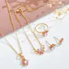 Conjunto de collar, aretes, pulsera y anillo con huella de pata de gato y corazón, estilo minimalista, transfronterizo - un regalo de joyería para mujer