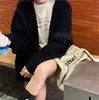 Cárdigan de punto suave y encerado Dongdaemun de Corea del Sur para mujer, nuevo estilo de otoño e invierno, chaqueta tipo suéter con cuello en V y estilo relajado.