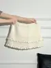 La popular falda midi de punto acanalado de color blanco roto de cintura alta en línea A con cordón para mujer de este año, estilo dulce y picante de otoño, falda corta tipo pastel adelgazante