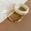 Pulsera Circular con Forma de Concha de Resina y Metal Chapado en Oro Ámbar, con un Toque de Lujo Ligero y de Alta Gama, Accesorio de Mano Simple y de Moda