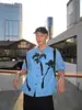 Camisa Masculina Estilo Coreano Tendência Verão 2025 Estilo Descolado e Bonito Gola Cubana Estampada Original Estilo Férias Moda Azul Manga Curta para Homens