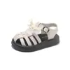 Zapatos de playa para niña con suelas blandas, zapatos de princesa versión coreana de verano, sandalias cerradas tejidas nuevas para niña 2026 con lazo