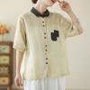 Foto Real da Camisa Artística Estampada de Algodão e Linho Novo Estilo 2026, Novo Modelo de Verão com Gola Reversível, Bolsos Canguru, Camisa de Manga Curta