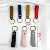 Llave de metal de cuero artificial PU doble cara de cuero -2 cuero pequeño llavero de regalo anillo de metal colgante simple 6g