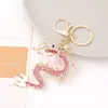 Artículo Popular Transfronterizo: Llavero Anillo de Metal con Pedrería de Dragón Chino con Animal del Zodiaco Dragón Volador, Venta al por Mayor de Pequeños Productos de Yiwu