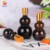Botella de vidrio de doble calabaza de color té para aceites esenciales, solución madre de esencia embotellada en forma de calabaza panacea 20 ml