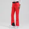 Pantalones de esquí profesionales de doble tabla para mujer, transfronterizos europeos y americanos, cortavientos, cálidos, impermeables, ajustados para exteriores, alta elasticidad para mujer