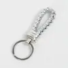 Llavero de cuerda de cuero tejido llavero creativo colgante colgante de pareja llavero cuerda colgante de bolsa de cuerda al por mayor