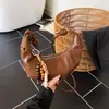 Bolso pequeño plisado con forma de cuerno transfronterizo para mujer, nuevo bolso casual versátil de moda otoño 2026, bolso de hombro y cruzado tipo dumpling