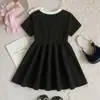 Comercio exterior transfronterizo Verano europeo y americano 26 nuevos modelos de elegantes vestidos de princesa negros con cuello redondo y lazo para bebés y niños pequeños, directo del fabricante