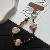 Cadena de muñeca para teléfono con diseño retro de cuadros, lunares, corazón y estrella, diseño corto con cuentas, amuleto de cámara CCD anti-pérdida