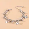 Moda de joyería nueva transfronteriza personalidad dulce pulsera de bola de mariposa conjunto de joyería de doble capa con borla de temperamento simple
