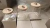 Entrega de fábrica Tarro sellado de vidrio de borosilicato alto vidrio resistente al calor tapa de bambú tarro para té tarro triangular tarro de almacenamiento botella de almacenamiento