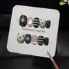 Padrão Estrela Marrom VerdeEsquema de Cores Chocolate MentaEstrelas Verdes Pintadas à MãoListras AzuisPoásRosa NudeUnhas Postiças Olho de Gato