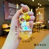 Llavero acrílico con forma de botella de arenas movedizas en aceite, regalo al por mayor, colgante de muñeca de donut, lindo llavero de arenas movedizas.