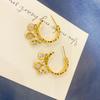 Nuevos pendientes de titanio con baño de oro real de 18K con incrustación de diamantes, hebilla de oreja flexible, estilo coreano Dongdaemun, fresco, temperamento de dama