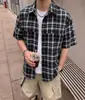 Camisa de manga corta a cuadros blancos y negros para hombre transfronteriza, camisa de trabajo de verano estilo Hong Kong, chaqueta versátil casual holgada al por mayor