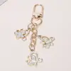 Estilo Nuevo Transfronterizo Europeo y Americano Ins Lujo Ligero Diamante Brillante Mariposa Llavero Moda de Alta Gama Estuche para Auriculares Decoración de Bolsos Accesorios
