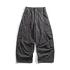 Yidao Vintage 2026 Otoño Nuevo Retro Americano Corte Asimétrico Bolsillo Grande Color Sólido Holgado Pierna Ancha Curva Pantalones de Trabajo