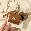 Nueva funda de espejo para auriculares de color sólido en forma de corazón, mini monedero simple, llavero portátil, accesorio de bolso de alta gama