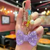 Chaveiro de Laço Cravejado com Diamantes, Moderno e de Alto Padrão, com Delicadas Contas de Cristal Coloridas, um Acessório Decorativo para Bolsas Femininas