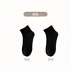 Calcetines blancos y negros para hombres y mujeres, calcetines de media pantorrilla para primavera y otoño, calcetines de algodón transpirables de color liso, calcetines deportivos para parejas, calcetines cortos de verano al por mayor