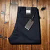 Estación europea verano delgado importado Tencel alta elasticidad ultradelgado transpirable Hombres sin planchado antiarrugas rectos ajustados casuales pantalones