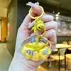 Llavero de Estrella de Cinco Puntas Acrílica con Concha de Estrella de Mar Rellena de Aceite y Arena Líquida Colgante para Mochila Decoración de Llavero Estrella Venta al por Mayor