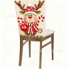 Fundas de silla navideñas superventas transfronterizas con diseños de muñeco de nieve y renos de dibujos animados, fundas para sillas de comedor y fundas para respaldos de decoración festiva, disponibles para venta al por mayor