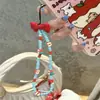 Princesa suelta moño rojo plano cadena de frutas para teléfono móvil contraste rojo y azul cadena colgante de cuentas diy cadena colgante para cámara ccd