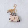 Criativo pequeno estilo perfumado PU pequena bolsa chaveiro franja porta-moedas portátil mini fones de ouvido bolsa pequena pingente atacado