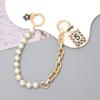 Yilian novo estilo Chanel Pérola cadeia portátil dupla cadeia pulseira pulseira caixa de telefone chaveiro-cadeia resistente a quedas atacado