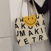 Bolsa de lona feminina grande capacidade nova estampa carinha sorridente estudante aula embalagem de livros com zíper bolsa de ombro atacado