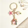 Llavero de hongo estilo cuento de hadas transfronterizo Temu, lindo colgante de aleación de casita con flor y aceite, decoración para bolso