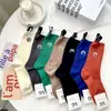 Calcetines de otoño e invierno para mujer de diseñador senior, tela con letras X pequeñas, calcetines hasta la mitad de la pantorrilla, color liso, etiqueta de cuero, calcetines para mujer