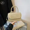 Bolsa Quadrada Pequena de Mola Estilo Hong Kong Ombro Único 2026 Nova Tendência Design de Nicho Moda Cor Sólida Bolsa Transversal de Alta Qualidade