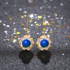 Acessórios de estilo chinês Método antigo Brincos de óleo de cloisonne banhados a ouro com incrustações de brincos de camélia de âmbar azul de segunda geração para mulheres