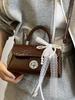 Bolsa cuadrada pequeña portátil de estilo coreano de alta gama, temperamento simple, nueva para primavera y verano, moda casual, todo-partido, bandolera de PU para mujer