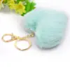 Venta caliente llavero de felpa de amor llavero de bola de pelo de corazón de melocotón colgante accesorios para equipaje de dama coche al por mayor