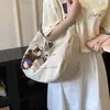 Bolsa de lona transfronteiriça para mulheres, nova bolsa tote da moda da primavera de 2026, bolsa transversal de grande capacidade para estudantes que frequentam aulas