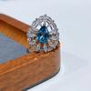 En la primavera de 2023, el nuevo anillo de topacio azul Londres de 7*10 mm con boca de anillo de plata S925 chapada en platino