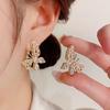 Pendientes de lazo geométrico con perlas y flores de nueva moda de Corea del Sur, de alta calidad, versátiles, ligeros, de lujo, con temperamento de celebridades de Internet.