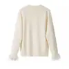 Ins transfronterizo europeo y americano 2026 nueva moda elegante ropa de mujer al por mayor cuello redondo versátil cárdigan de punto decorado con plumas