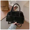 Bolso cuadrado pequeño de color liso estilo coreano de alta gama para mujer, nuevo de 2026, bolso de mano simple para hombro y cruzado con diseño de nicho