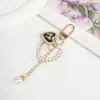 Llavero Colgante Forma de Corazón con Lazo y Perlas Estilo Chanel para Funda de Teléfono Bolso Encanto Regalo Pequeño Accesorios DIY